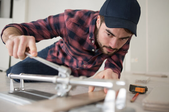 workman cutting ceramic tiles