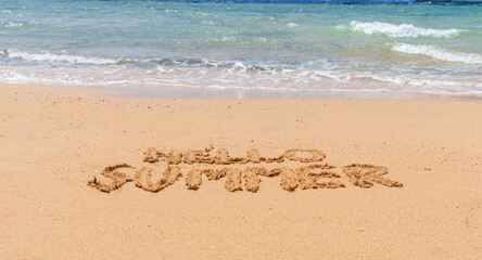 Fototapeta premium Hello summer words concept. Concept word Hello summer written on beautiful Red sea sand beach. Beautiful Red sea ocean sand beach background, copy space. Business travel Hello summer concept.