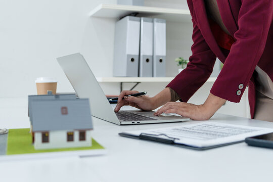 Close-up of Miniature House Models and Keys on Desk