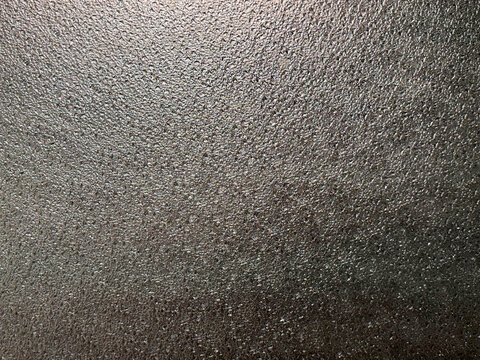 Close up of dark grey linen wallpaper or fabric. Graphic background. Dark grey linen and denim pattern seamless background texture.