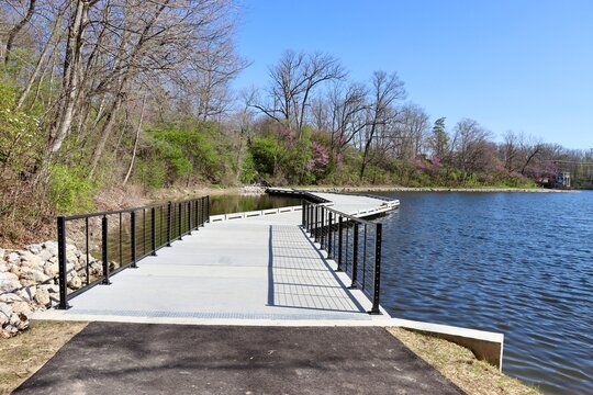 The cement footbridge at the lake on a sunny day.