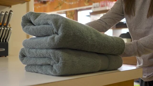 A freshly folded towel sitting on a counter top.