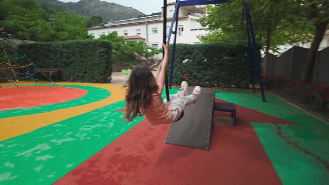 Happy Child Enjoys Thrilling Ride on Zip Line in a Colorful Park
