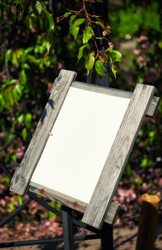 Blank wooden sign mockup in the garden