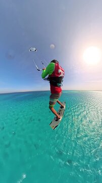 extreme kitesurfer performing dangerous stunt lifted high by boat releasing rope midair landing on turquoise sea continuing fast ride freedom adventure adrenaline water sport lifestyle summer outdoors