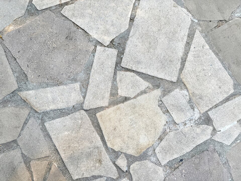 Natural random cut white flagstone flattened on a surface. Or a series of cobble stones but flattened and paved seamlessly, for floor or wall finishes
