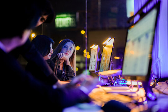 Technical specialist evaluating big data infrastructure and autonomous system security. Modern tech expert monitoring server status and privacy preserving AI models at a glowing workplace.