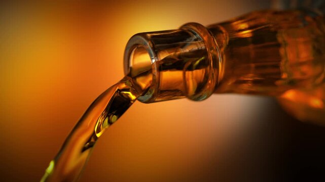Super Slow Motion of Pouring Whiskey From Glass Bottle Attached to Camera at 1000fps.