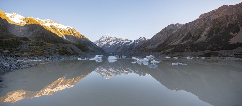 Sunrise, reflection in Hooker Lake, morning sun illuminating Mount Cook, Mount Cook National Park, Southern Alps, Hooker Valley, Canterbury, South Island, New Zealand