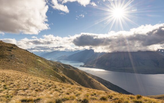 Sun shining, lake surrounded by mountains, Lake Hawea, view from Isthmus Peak, Otago, South Island, New Zealand