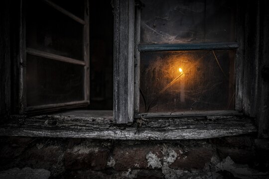 Old decayed wooden window on old house facade in candlelight, Mindelheim, Unterallg&auml;u, Bavaria, Germany