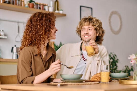 Young couple enjoying breakfast together in their cozy modern apartment