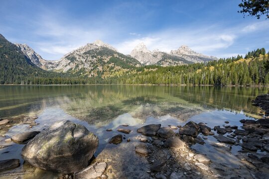 Reflection in Taggart Lake, view of the Teton Range, peaks Grand Teton and Teewinot Mountain, autumn, Grand Teton National Park, Wyoming, USA