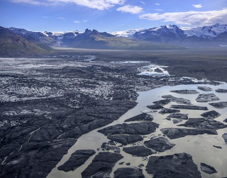 Glacial lake with icebergs coloured by lava sand, aerial photo, Skaftafell, Austurland, Iceland