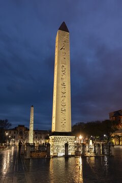 Illuminated Egyptian obelisk and brick obelisk on the Hippodrome in the evening, also Sultanahmet Squarean part, Istanbul, Turkey