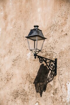 Street lamp on a brick wall, Bonifacio, Corsica, France