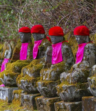 Jizo statues with red caps, protective deities for deceased children, Kanmangafuchi Abyss, Nikko, Japan