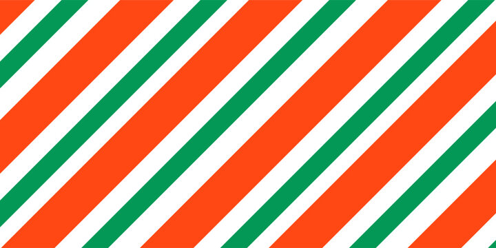 Christmas seamless pattern. Red and green diagonal stripes background. Candy cane repeating decoration wallpaper. Winter holiday lines backdrop. Xmas peppermint present wrapping print design. Vector
