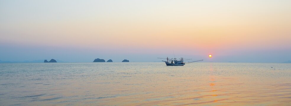 Boat in the sea at sunset in front of small islands, Koh Samui, Gulf of Thailand, Thailand