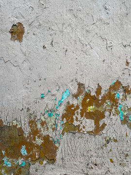 Fragmented facade revealing historical strata of pigment and concrete, a study in urban entropy
