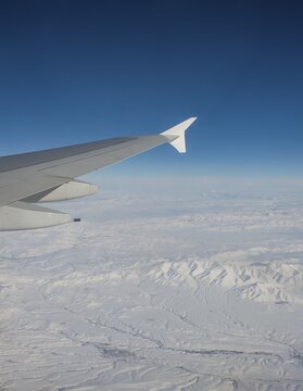 View of mountains and snowy landscape from the airplane, airplane wing of an Airbus A380, aerial view, Anatolia, Northeastern Turkey, Turkey