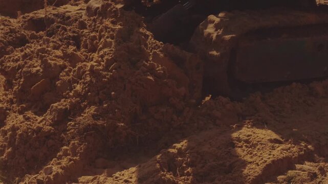 The process of the mini tractor, tractor driver, tractor uproots a tree, removal of roots by tractor