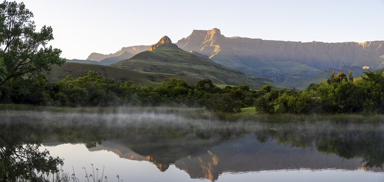 Sunrise, amphitheatre with reflection in the lake, Royal Natal National Park, Drakensberg Mountains south, Kwa Zulu Natal, South Africa
