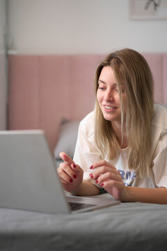 Smiling at the Screen During a Cozy Morning Online