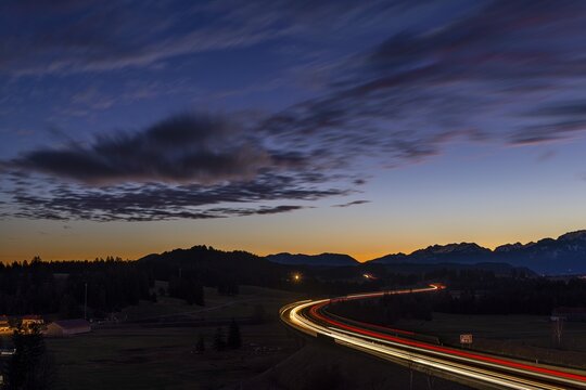 Motorway at blue hour with traces of cars in Allg&auml;u landscape, Seeg, Ostallg&auml;u, Bavaria, Germany