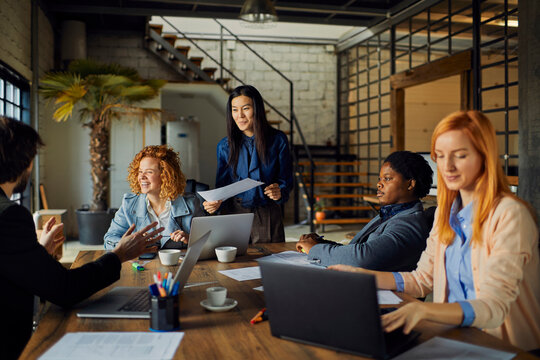 Diverse coworkers collaborating in modern loft office