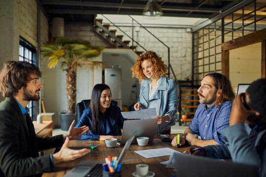 Creative team brainstorming in modern loft office