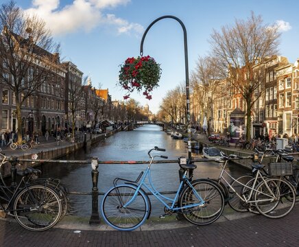 Parking bicycle on bridge over canal at Oudezijds Voorburgwal, behind Sint Nicolaaskerk, Sankt Nikolas church, Amsterdam, North Holland, Netherlands
