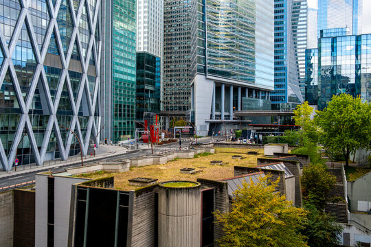 Green rooftop highlights sustainable corporate skyscraper architecture in Paris business district at La Defense with modern urban skyline and office towers
