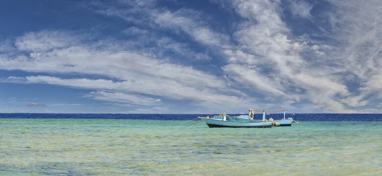 Fishing boats in the turquoise sea at the coral reef Abu-Dabbab, Hilton Nubian Resort, Al Qusair, Marsa Alam, Egypt