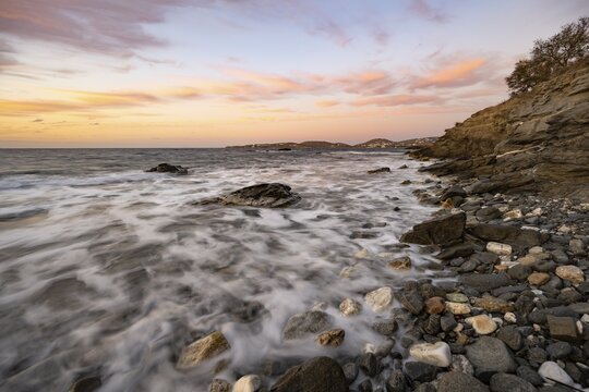 Long time exposure, waves at the sea, coast near Parikia with sunset, Paros, Cyclades, Aegean Sea, Greece