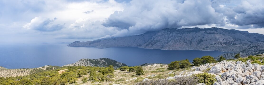 View over the island and coast to the sea, rocky landscape with macchia, Symi, Dodecanese, Greece