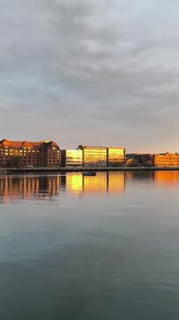 Scenic sunset over Copenhagen harbor with boat silhouette