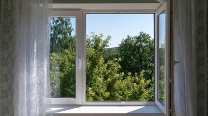 Fototapeta premium Inviting opened white plastic window with lace curtains and a vibrant green tree view under summer sunlight.