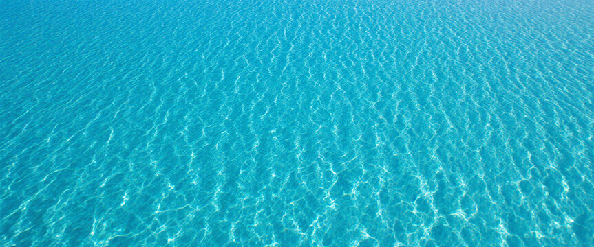 An aerial view of a large region of clean, clear, blue water ripples