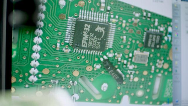 Magnified View of Electronic Circuit Board on Monitor During Lab Inspection