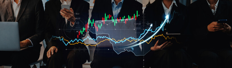Obraz premium A group of business professionals engaged in financial data analysis, surrounded by stock market graphs on screens, showcasing teamwork and modern technology usage. Scalp