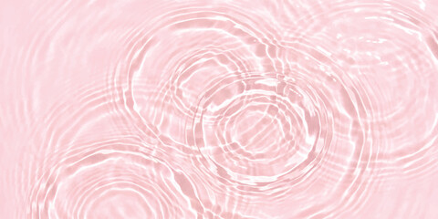 Pink water ripples on a liquid surface with soft circular waves and light reflections creating a calm texture © GraphixEra