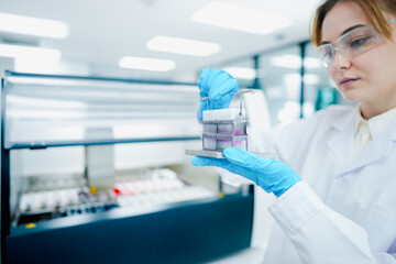 Fototapeta premium Clinical laboratory scientist monitoring automated hematology analyzer workflow metrics via digital LIMS tablet interface in smart diagnostic facility.