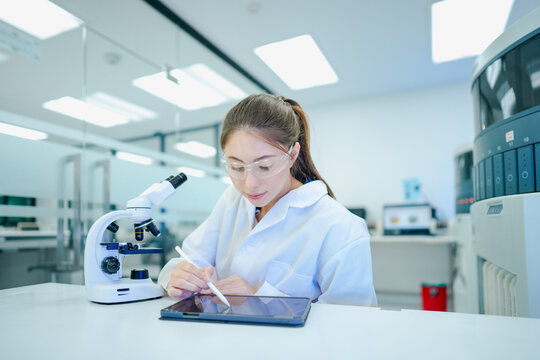Medical technologist validating automated analyzer results against microscopic observations. Biomedical engineer configuring diagnostic instrument parameters using digital control interface.