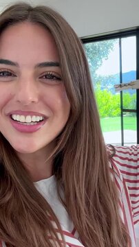 Joyful young woman with a radiant smile holding the keys to her new apartment, celebrating a significant milestone like purchasing her first home or renting a new property with excitement