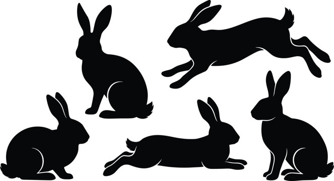 Set of black rabbit and hare silhouettes in various poses including running jumping and sitting isolated on white background