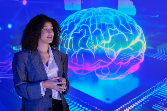 Speaker in a professional outfit presents the business technology concepts at a technology conference