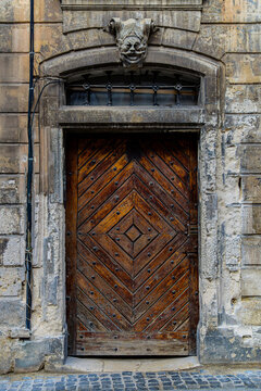 Ancient wooden door with stone mascaron