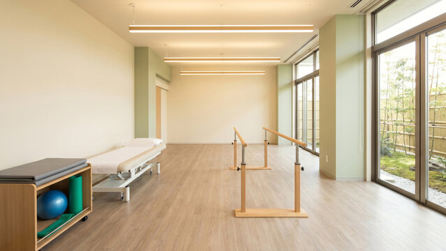 Sunlit Rehabilitation Therapy Room with Parallel Bars and Bamboo Garden View Toward Recovery Hope and Vitality Perfect for Physical Therapy Branding and Healthcare Recruitment Advertising