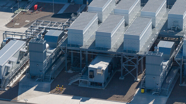 Aerial view of Datacenter Westpoort featuring cooling units, metal structures, and solar panels on a clear day in Groningen, Groningen, Netherlands.